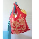 Tote bag hanging on the back of a chair.