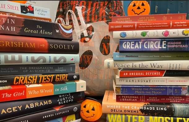 stacks of books with Halloween themed decorations.