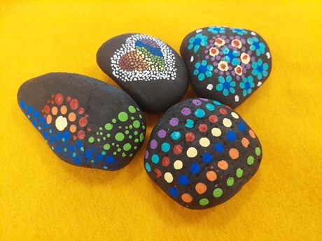 four rocks on a felt mat