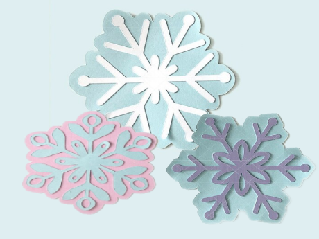 three paper snowflakes