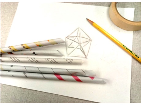 A drawing of a space structure, newspaper sticks, pencil, and tape