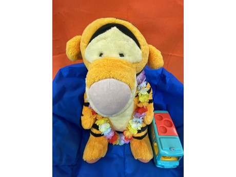 Stuffed Animal Tigger and a toy bus