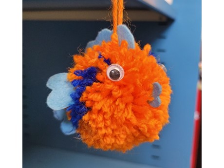orange and blue yarn pom pom fish