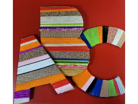 cardboard alphabet letters wrapped in yarn