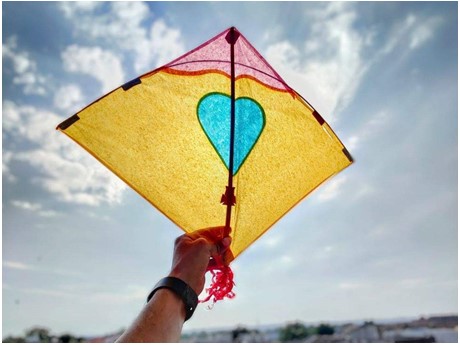 Kite being held up to the sky.