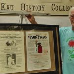 Photo of Mark Twain Festival posters and Friends of the Ka`u Libraries member