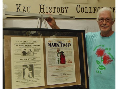 Photo of Mark Twain Festival posters and Friends of the Ka`u Libraries member