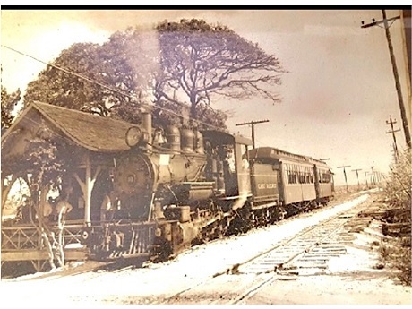 Sepia photo of steam locomotive passenger train at old Ewa Station