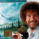 Painter Bob Ross in front of one of his landscape paintings.