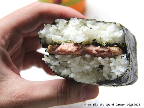 Hand holding a spam musubi,