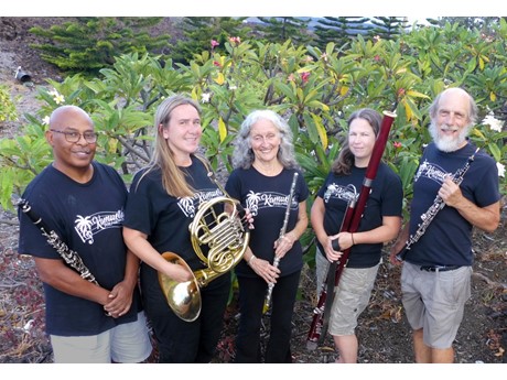 Photo of five members of the West Hawaii Woodwind Quintet, holding their musical instruments