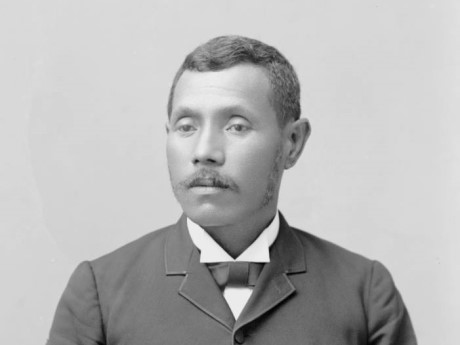 photograph showing head and shoulders of Hawaiian man, Joseph Nawahi, wearing a19th century suit.