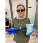 Photo of Margaret Bourget holding sewing kit and small pillow