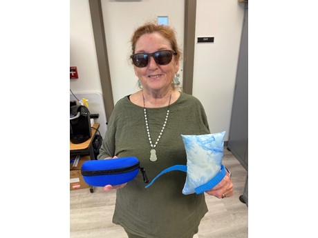 Photo of Margaret Bourget holding sewing kit and small pillow