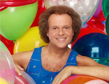 Fitness personality Richard Simmons surrounded by colorful balloons