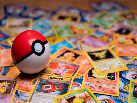 pokeball on top of a bunch of pokemon cards