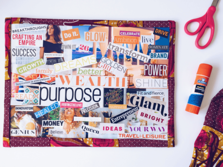 A vision board with glue and scissors next to it.