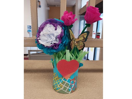 one tissue paper flower, two crepe paper flowers and a handmade vase