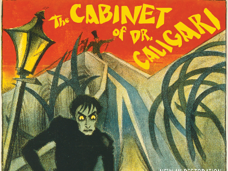 Top half of the movie poster for the 1919 silent film, "The Cabinet of Dr. Caligari." The title of the movie is in yellow over a red field. Underneath is an old-fashioned lamp post, and the gaunt figure of a vampire.