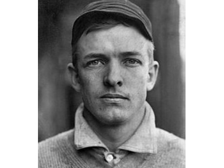 Black and white close-up photo of early 20th century baseball player Christy Mathweson in his baseball uniform.