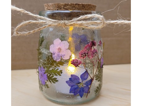 glass jar with dried flowers glued on