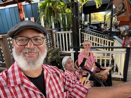 Men playing instruments outside ukulele guitar