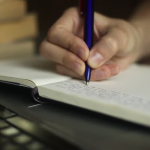 pen writing in a notebook