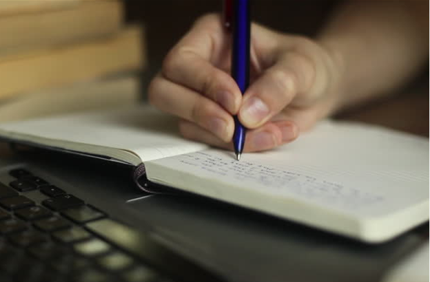 pen writing in a notebook