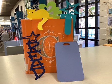 Paper bookmarks displayed on a hardback book