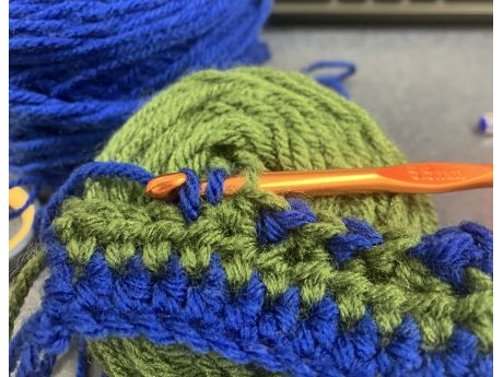 crochet project in progress with hook and yarn
