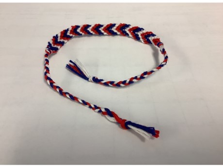 a red, white, and blue friendship bracelet in a chevron pattern