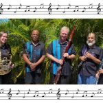 woodwind quintet, 5 people with instruments, outside, bordered by music notes