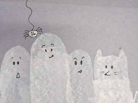 Blue construction paper background with smeared white paint to make ghosts and a spider hanging from the top