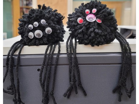 two yarn made pom-pom spiders