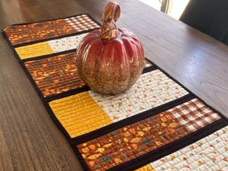 Table decorated with a fall-themed table runner