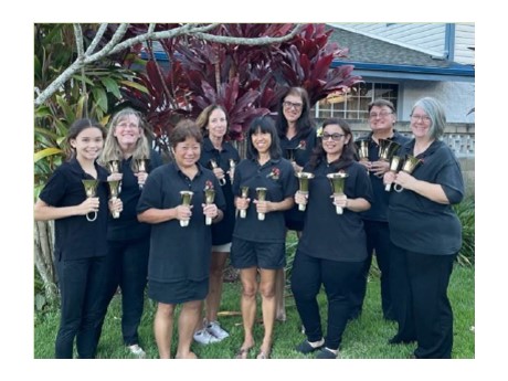 a group of people holding bells