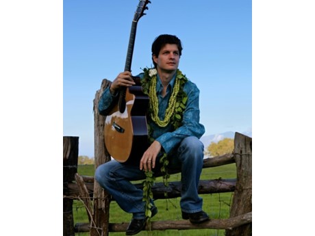 Jeff Peterson holding slack key guitar