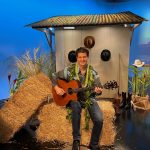 Jeff Peterson on set witih guitar