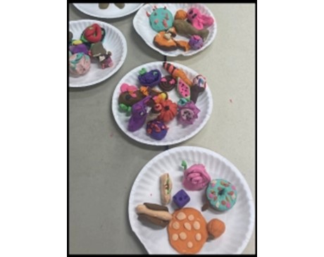 several plates of food items made with clay