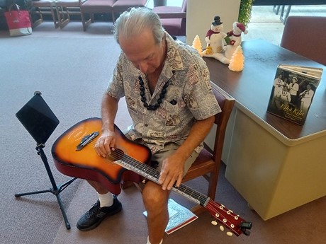 male playing Hawaiian Lap Steel Guitar