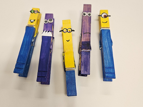 5 clothes pins colored to look like minions (blue and yellow or purples) with eyes and mouths