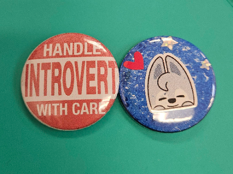 Two buttons, "Handle introvert with care" and Blue background button with a tiny pink heart and Wolf-chan sticker.