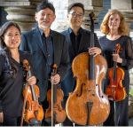 A group of people holding instruments