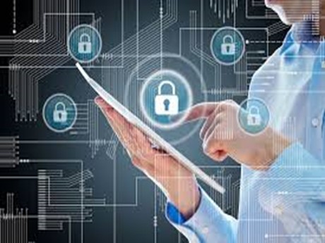Person holding a tablet surrounded by lock icons denoting security.