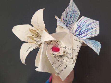 Three origami flowers made from repurposed book pages