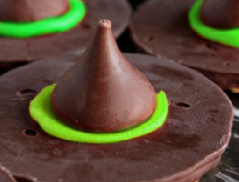 a chocolate cookie topped with a "rim" of neon green icing and topped off with a chocolate kiss