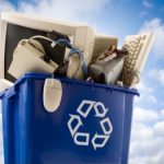 Blue recycling bin with outdated electronics