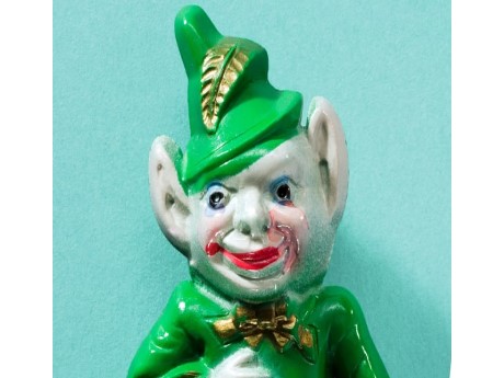 A creepy ceramic leprechaun with grey skin and bat ears, dressed in a green suit.