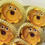 cheese with scalloped edge and a round cracker on top, topped with a smaller round cracker and eyes and nose