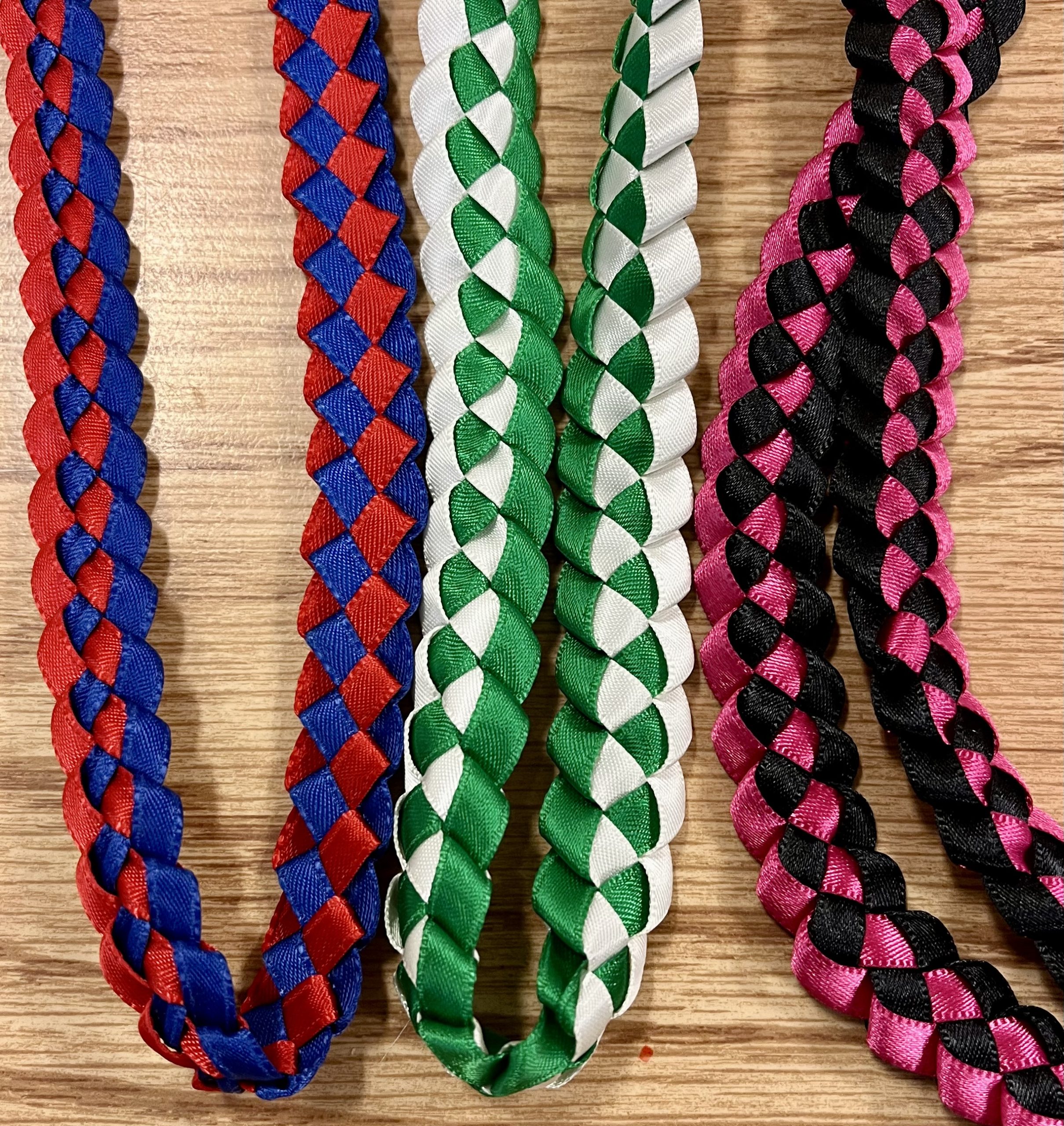 a set of 3 braided satin ribbon leis in different colors